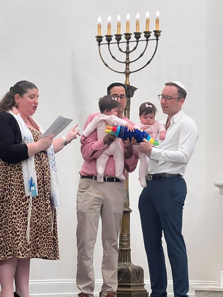 Two congregants and their daughters as one partner and the girls finalized their conversion. Fun fact: I officiated at the dads' wedding on the same bima!